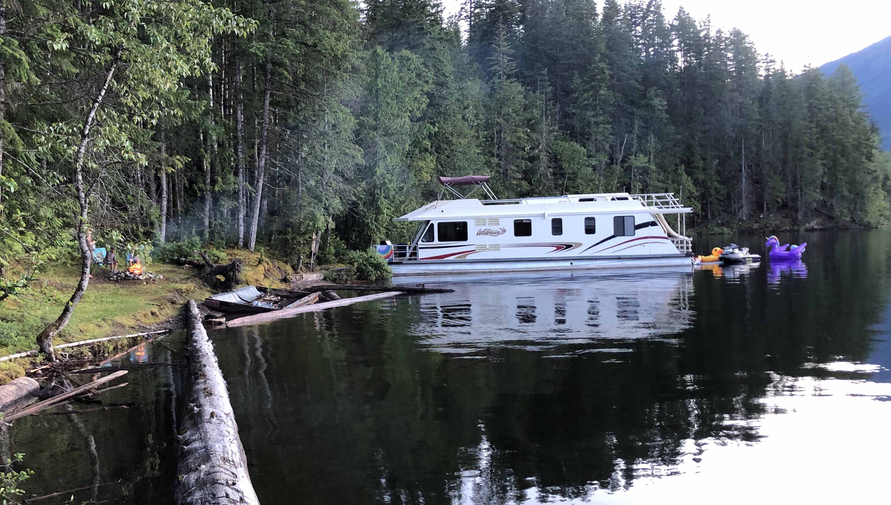 Guests enjoying the sunset on the beach on Shuswap lake.